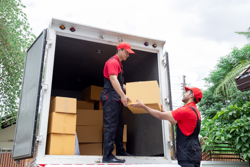Indian,And,Caucasian,Partnership,Mover,Workers,In,Red,Uniform,Uploading